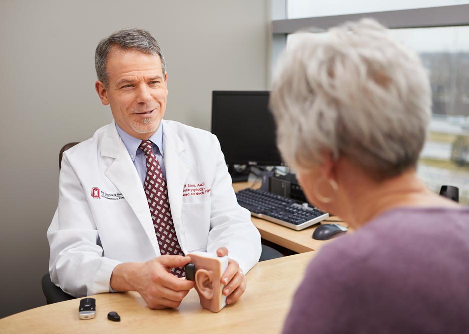 Audiologist and patient discuss hearing aid options for her hearing loss